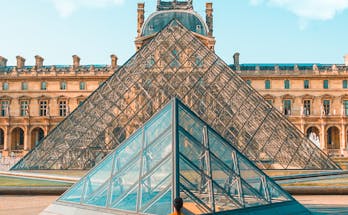 Man Standing in Front of Louvre Museum of Paris